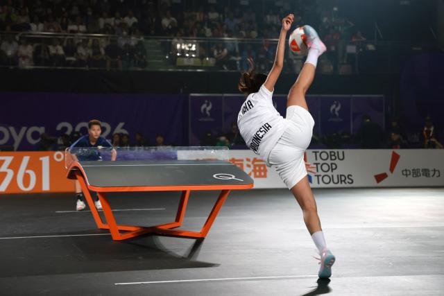 Indonesia's Sumaya (R) serves to Myanmar's Wai Khin Hnin during their women's singles final teqball match at the 2026 Asian Games in Nagoya on September 20, 2026. (Photo by DAVID GRAY / AFP)
