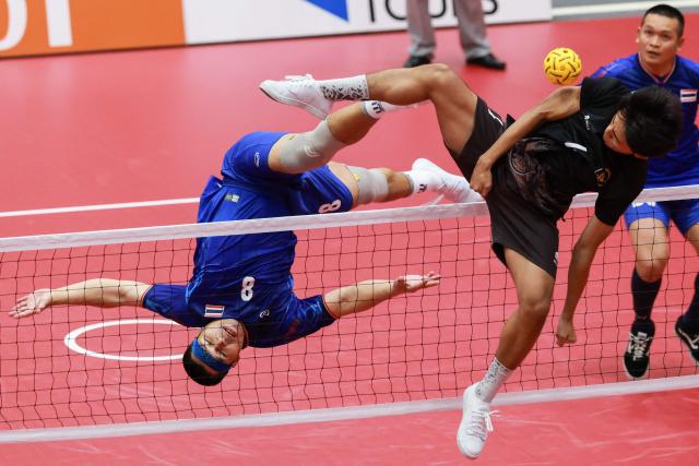 Thailand's Pichet Pansan (L) kicks the ball during the men's team regu sepak takraw match between Thailand and Indonesia at Nagoya City Mizuho Park Gymnasium in Nagoya on September 21, 2026. (Photo by DAVID GRAY / AFP)