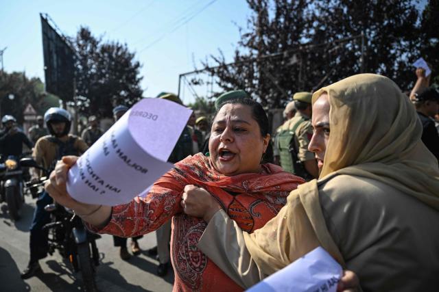 A police personnel detains a supporter of the Jammu and Kashmir Apni Party (JKAP) during a protest against the government demanding employment for youth and basic amenities in Srinagar on September 21, 2026. (Photo by Tauseef MUSTAFA / AFP)