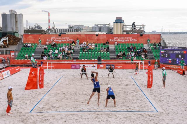 Iran's Abbas Pouarasgari (front L) serves in the men's beach volleyball match between Iran and East Timor during the 2026 Asian Games at the Hekinan Ryokuchi Beach Court in Hekinan, Aichi prefecture on September 21, 2026. (Photo by DAVID GRAY / AFP)