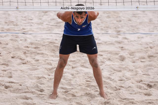 Iran's Abbas Pouarasgari prepares to play a point in the men's beach volleyball match between Iran and East Timor during the 2026 Asian Games at the Hekinan Ryokuchi Beach Court in Hekinan, Aichi prefecture on September 21, 2026. (Photo by DAVID GRAY / AFP)
