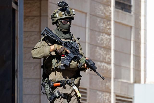 An Israeli soldier conducts a raid in the Palestinian town of Beddu, northwest of Jerusalem on September 21, 2026, a day after they arrested a man suspected of killing an Israeli, reported to be a settler, according to Israel's military. "IDF soldiers apprehended the terrorist who carried out the shooting attack," the army said in a statement, adding that it located him at a hospital, which Palestinian sources said was in the city of Ramallah. The army said a soldier had earlier shot and wounded the suspected assailant at the scene of the incident near Ramallah in the central West Bank. (Photo by Zain JAAFAR / AFP)