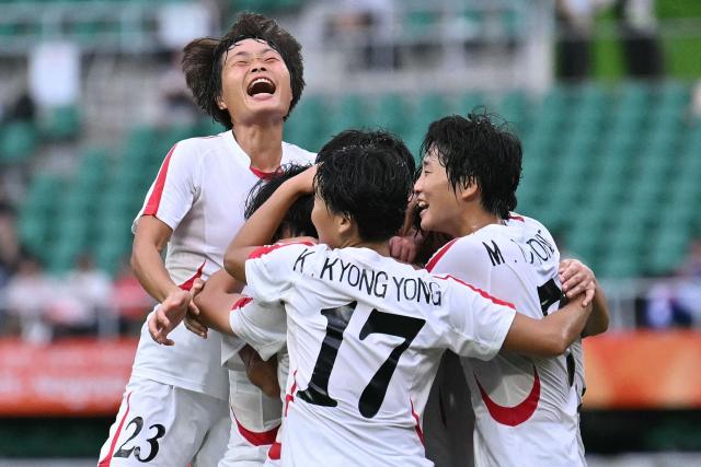 Players celebrate a goal by North Korea's midfielder #20 Chae Un Yong in the women's Group F football match against South Korea during the 2026 Asian Games at the Shizuoka Stadium Ecopa in Fukuroi, Shizuoka prefecture on September 21, 2026. (Photo by MOHD RASFAN / AFP)