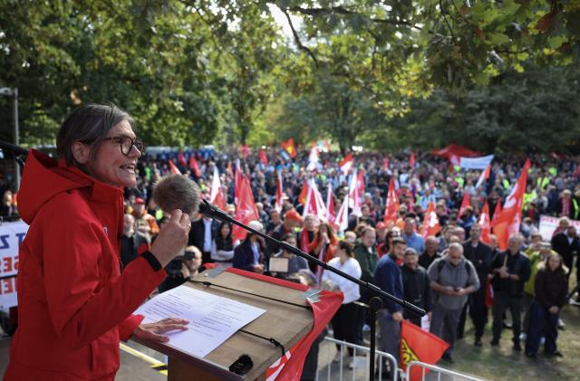 Christiane Benner, chairwoman of the industrial union IG Metall, addresses workers during a protest against job cuts in front of the commercial cars plant of German car maker Volkswagen (VW) on September 21, 2026 in Hanover, central Germany. The metalworkers' IG Metall union has called for nationwide protests at manufacturers and suppliers in the automotive industry, claiming government and management action to protect jobs and factories as the car industry hits crisis point. (Photo by Ronny HARTMANN / AFP)