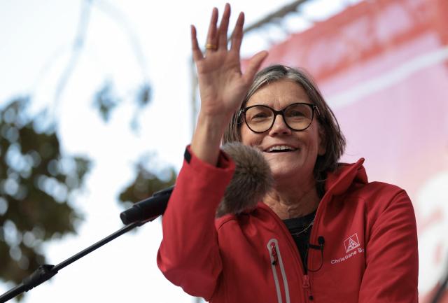 Christiane Benner, chairwoman of the industrial union IG Metall, addresses workers during a protest against job cuts in front of the commercial cars plant of German car maker Volkswagen (VW) on September 21, 2026 in Hanover, central Germany. The metalworkers' IG Metall union has called for nationwide protests at manufacturers and suppliers in the automotive industry, claiming government and management action to protect jobs and factories as the car industry hits crisis point. (Photo by Ronny HARTMANN / AFP)
