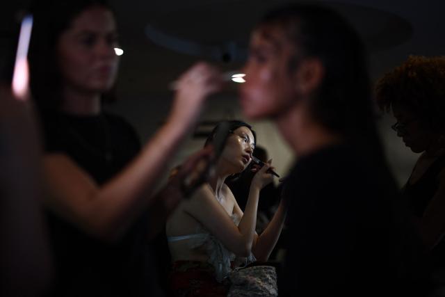 Models are prepared backstage ahead of the catwalk show for the DI PETSA Spring/Summer 2027 collection at London Fashion Week in London on September 21, 2026. (Photo by Henry Nicholls / AFP)