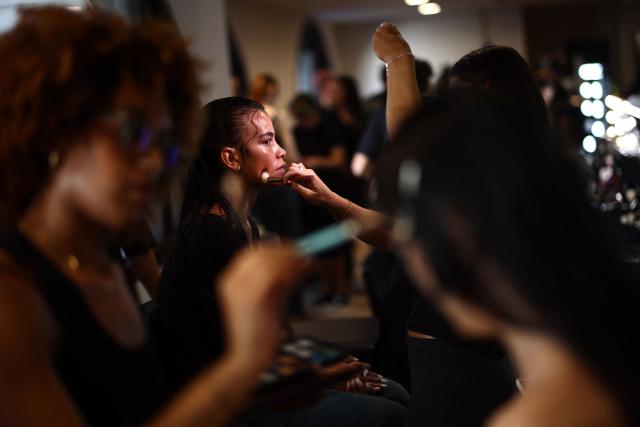 Models are prepared backstage ahead of the catwalk show for the DI PETSA Spring/Summer 2027 collection at London Fashion Week in London on September 21, 2026. (Photo by Henry Nicholls / AFP)