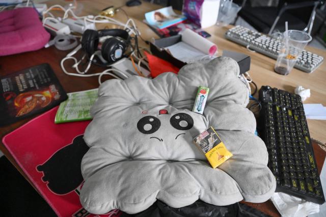 Chewing gum and a pack of cigarettes are seen on a pillow beside abandoned equipment at a closed cyber scam centre in Bavet town, Svay Reang province on September 21, 2026. Cambodia this week hosts officials from more than 20 countries for a conference on combating online scammers, seeking to showcase its own crackdown under increasing international pressure. (Photo by TANG CHHIN SOTHY / AFP)