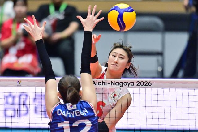 Japan's Miku Akimoto hits the ball past South Korea's Lee Da-hyeon in the women's volleyball semi-final match between Japan and South Korea during the 2026 Asian Games at the Park Arena Komaki in Komaki, Aichi prefecture on September 21, 2026. (Photo by JIJI PRESS / AFP) / Japan OUT