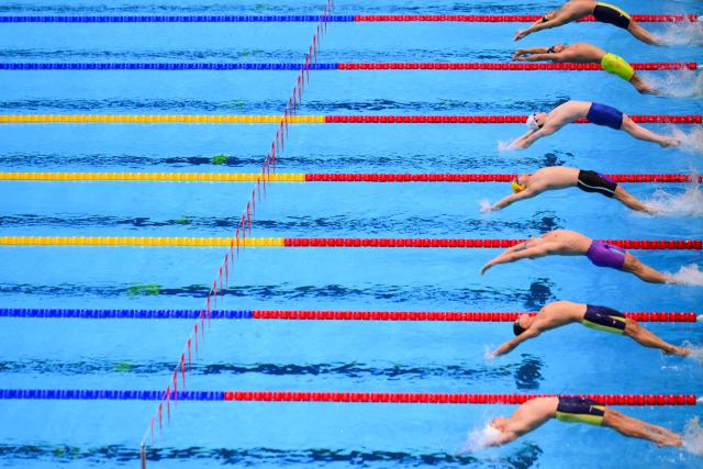 Swimmers compete in the final of the men's 50m backstroke swimming event during the 2026 Asian Games at the Tokyo Aquatics Centre in Tokyo on September 21, 2026. (Photo by Yuichi YAMAZAKI / AFP)