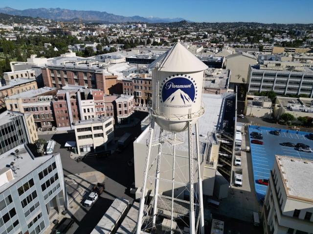 (FILES) This aerial view shows the water tower with the Paramount logo at Paramount Studios in Los Angeles, California, on December 9, 2025. Paramount has reached a settlement with a group of US states that clears the way for its takeover of Warner Bros. Discovery, US media reported on September 21, 2026, creating a Hollywood behemoth spreading from television to cinema. Paramount, which is run by David Ellison, whose ultra-wealthy family is closely allied with US President Donald Trump, launched the blockbuster bid for control of a stable of assets that includes Warner Bros. Pictures, CNN and the HBO Max streaming service. (Photo by Robyn Beck / AFP)