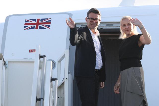 Britain's Prime Minister Andy Burnham and his wife Marie-France van Heel board a plane for the United States, to attend the 81st United Nations General Assembly (UNGA) in New York City, at Stansted Airport, north of London on September 21, 2026. (Photo by Toby Melville / POOL / AFP)