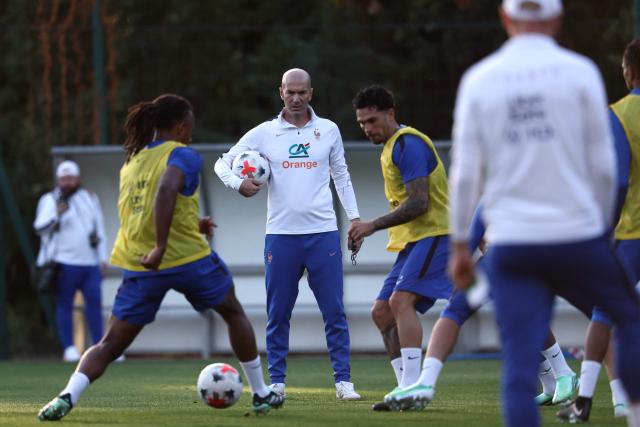 France's head coach Zinedine Zidane (C) looks at his players practicing during a training session four days ahead of France's UEFA Nations League football match against Turkey in Clairefontaine-en-Yvelines outside Paris, on September 21, 2026. The gathering is the first of the French national team under its new coach Zinedine Zidane, appointed on July 28, 2026 on a four-year contract. The Nations League, which France won in 2021, will dominate Zidane's attention in the coming months before the draw for the Euro 2028 qualifying tournament takes place in early December. (Photo by FRANCK FIFE / AFP)