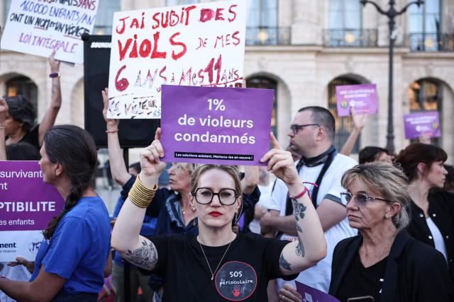 A protester holds a placard reading "One percent of rapists sentenced" during a demonstration calling for the protection of children and a comprehensive law against sexual violence, organised by the Feminist and Child Rights Coalition for a Comprehensive Framework Law Against Sexual Violence outside the Justice Ministry on Place Vendome in Paris on September 21, 2026. Some 130 gatherings were announced across France as lawmakers began debates on a "comprehensive" bill against gender-based and sexual violence. (Photo by SIMON WOHLFAHRT / AFP)