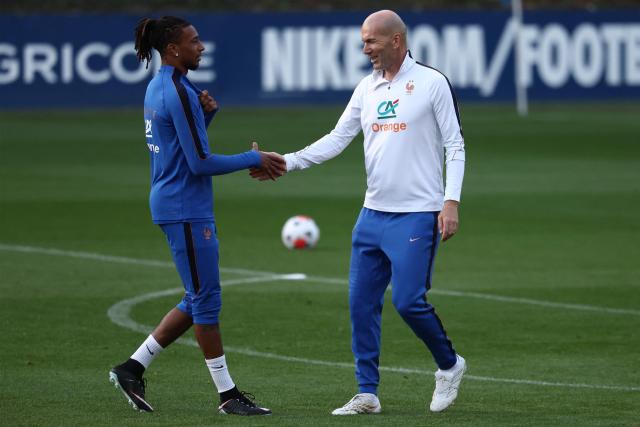 France's head coach Zinedine Zidane (R) shakes hands with France's forward Michael Olise (L) at the end of a training session four days ahead of France's UEFA Nations League football match against Turkey in Clairefontaine-en-Yvelines outside Paris, on September 21, 2026. The gathering is the first of the French national team under its new coach Zinedine Zidane, appointed on July 28, 2026 on a four-year contract. The Nations League, which France won in 2021, will dominate Zidane's attention in the coming months before the draw for the Euro 2028 qualifying tournament takes place in early December. (Photo by FRANCK FIFE / AFP)