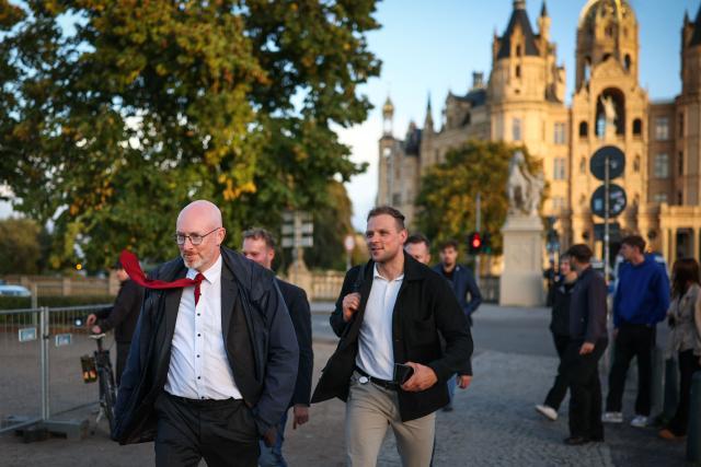 Christian Pegel (L, SPD), Minister of the Interior of Mecklenburg-Western Pomerania arrives at the TV compound after the announcement of the first exit poll results near the Schwerin Castle, on September 20, 2026, following north-eastern Germany's Mecklenburg-Western-Pomerania's state elections. (Photo by Ronny HARTMANN / AFP)