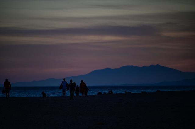 People walk at sunset in Portirages, southern France, on September 21, 2026. (Photo by Gabriel BOUYS / AFP)