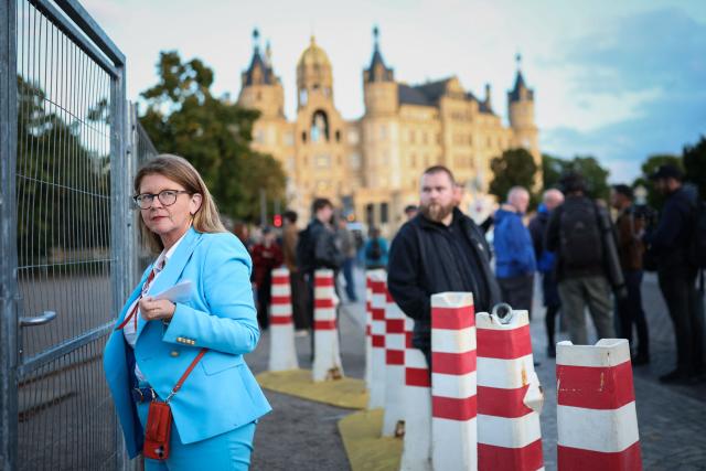 Simone Borchardt (CDU), Member of the Bundestag representing Mecklenburg-Western Pomerania and health policy spokesperson for the CDU/CSU parliamentary group in the Bundestag, is waiting to be let in at the entrance to the TV compound after the announcement of the first exit poll results near the Schwerin Castle, on September 20, 2026, following north-eastern Germany's Mecklenburg-Western-Pomerania's state elections. (Photo by Ronny HARTMANN / AFP)