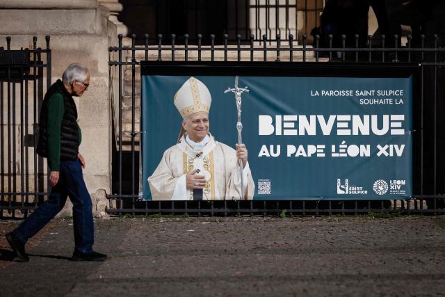 A person walks past a banner reading "The Saint-Sulpice parish welcomes Pope Leo XIV" four days ahead of the pontiff's apostolic visit to Paris in Paris on September 21, 2026. (Photo by Simon WOHLFAHRT / AFP)