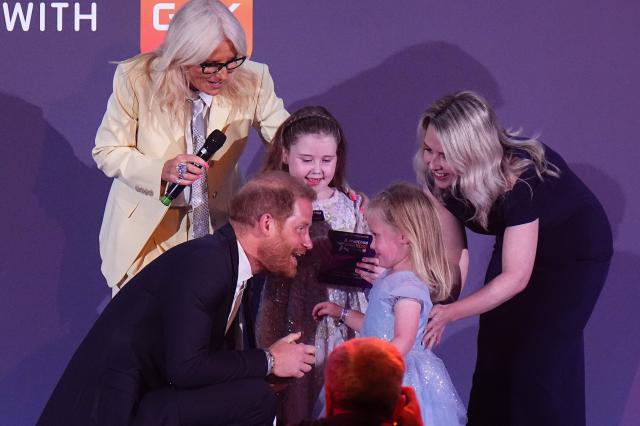Britain's Prince Harry, Duke of Sussex speaks to Margot Jones-Billington’s sister Adeleigh on stage during the annual WellChild Awards at the Royal Lancaster Hotel in London on September 21, 2026. WellChild is the national charity for seriously ill children and their families. The WellChild Awards celebrate the inspiring qualities of some of the country's seriously ill young people and the dedication of those who care for and support them. (Photo by Aaron Chown / POOL / AFP)