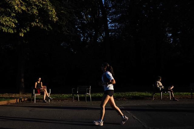 A woman jogs in a park at sunset in Lille, northern France, on September 21, 2026. (Photo by Sameer Al-DOUMY / AFP)
