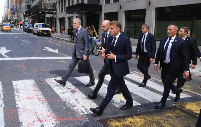 French President Emmanuel Macron (R) walks with Jerome Bonnafont (L), Permanent Representative of France to the United Nations and France’s Foreign Affairs Minister Jean-Noлl Barrot (C) as they head to Trump Tower in New York City on September 21, 2026, ahead of a meeting with US President Donald Trump. (Photo by Ludovic MARIN / AFP)