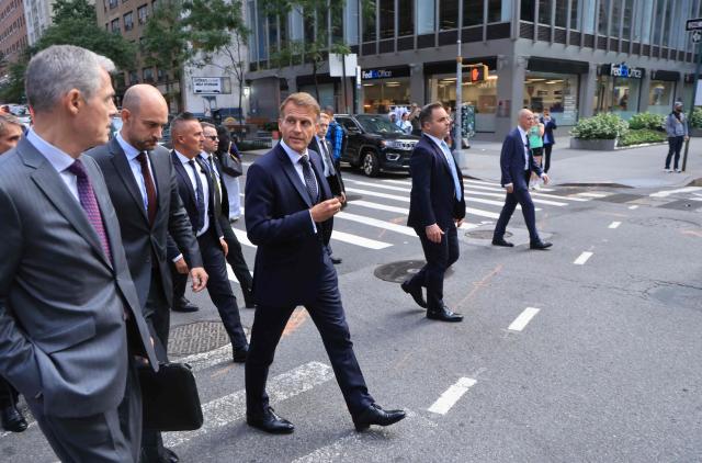 French President Emmanuel Macron (R) walks with Jerome Bonnafont (L), Permanent Representative of France to the United Nations and France’s Foreign Affairs Minister Jean-Noлl Barrot (C) as they head to Trump Tower in New York City on September 21, 2026, ahead of a meeting with US President Donald Trump. (Photo by Ludovic MARIN / AFP)