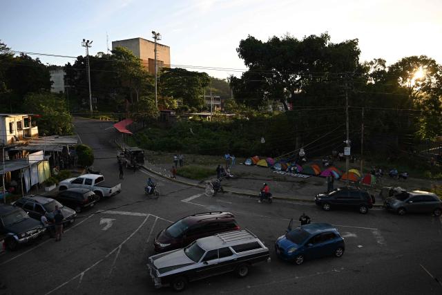 (FILES) Relatives of inmates camp while waiting for news about the release of prisoners outside El Rodeo I prison in Guatire, Miranda State, some 30 kilometers east of Caracas on January 13, 2026. Gloomy cells, hooded guards, dark uniforms and torture in the "time capsule" are among the memories carried by political prisoners who have been held at El Rodeo I, which has become Venezuela's most feared detention centre since the closure of the infamous Helicoide. (Photo by Federico PARRA / AFP)