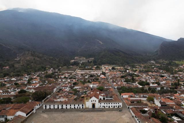 This aerial view shows Villa de Leyva as smoke rises from a wildfire on Ritoque Hill in Boyaca department, Colombia, on September 21, 2026. (Photo by Raul ARBOLEDA / AFP)