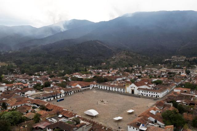 This aerial view shows Villa de Leyva as smoke rises from a wildfire on Ritoque Hill in Boyaca department, Colombia, on September 21, 2026. (Photo by Raul ARBOLEDA / AFP)