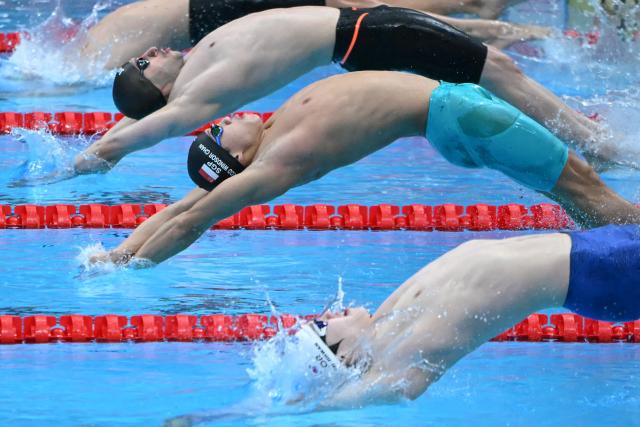 Singapore's Tedd Windsor Iii Heng Kai Chan (C) competes in a heat of the men's 4 x 100m medley relay swimming event during the 2026 Asian Games at the Tokyo Aquatics Centre in Tokyo on September 22, 2026. (Photo by ANDREW CABALLERO-REYNOLDS / AFP)