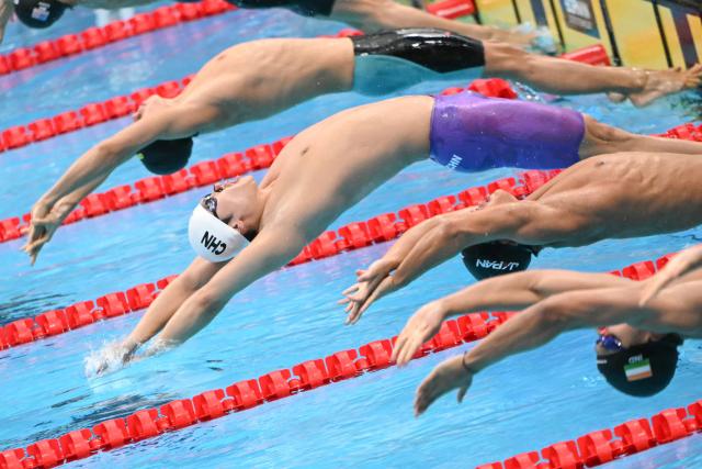 China's Jiang Chenglin (C) competes in a heat of the men's 4 x 100m medley relay swimming event during the 2026 Asian Games at the Tokyo Aquatics Centre in Tokyo on September 22, 2026. (Photo by ANDREW CABALLERO-REYNOLDS / AFP)