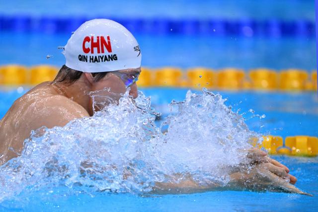 China's Qin Haiyang competes in a heat of the men's 4 x 100m medley relay swimming event during the 2026 Asian Games at the Tokyo Aquatics Centre in Tokyo on September 22, 2026. (Photo by Yuichi YAMAZAKI / AFP)