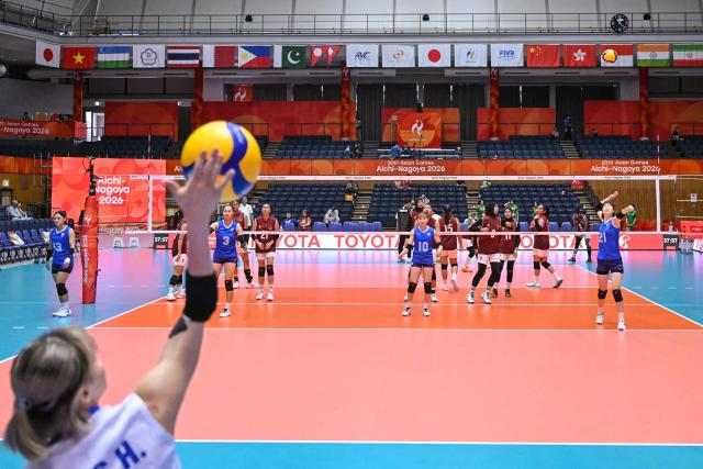 Taiwan's players (blue) warm-up before the women's volleyball match between Taiwan and Indonesia during the 2026 Asian Games at the Park Arena Komaki in Komaki, Aichi prefecture on September 22, 2026. (Photo by MOHD RASFAN / AFP)
