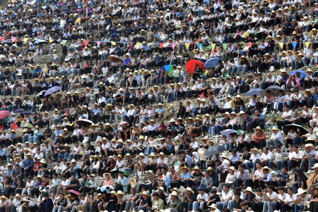 People watch a bullfight in Zaibian located in Congjiang County, in China's southwest Guizhou province on September 19, 2026. (Photo by CN-STR / AFP) / China OUT