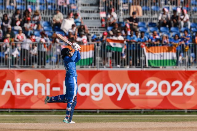 India's Smriti Mandhana hits a six in the women's gold medal cricket match between India and Sri Lanka during the 2026 Asian Games at Korogi Athletic Park in Nisshin, Aichi prefecture on September 22, 2026. (Photo by DAVID GRAY / AFP)