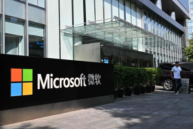 A man walks past the logo of the US tech company Microsoft in front of its office in Beijing on September 22, 2026. (Photo by ADEK BERRY / AFP)