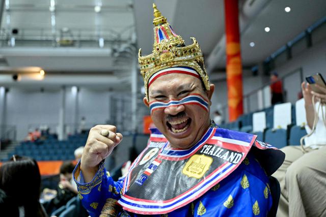 A spectator with Thailand's national flag painted on his face reacts before the start of the women's volleyball bronze medal final match between South Korea and Thailand during the 2026 Asian Games at the Park Arena Komaki in Komaki, Aichi prefecture on September 22, 2026. (Photo by MOHD RASFAN / AFP)