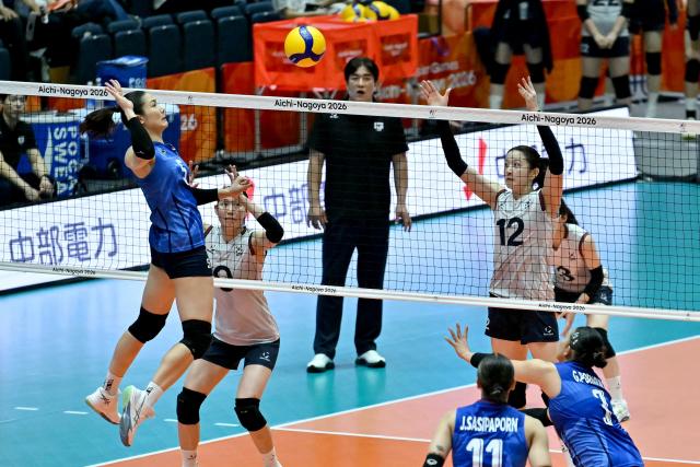 Thailand's Thatdao Nuekjang (L) spikes the ball in the women's volleyball bronze medal final match between South Korea and Thailand during the 2026 Asian Games at the Park Arena Komaki in Komaki, Aichi prefecture on September 22, 2026. (Photo by MOHD RASFAN / AFP)