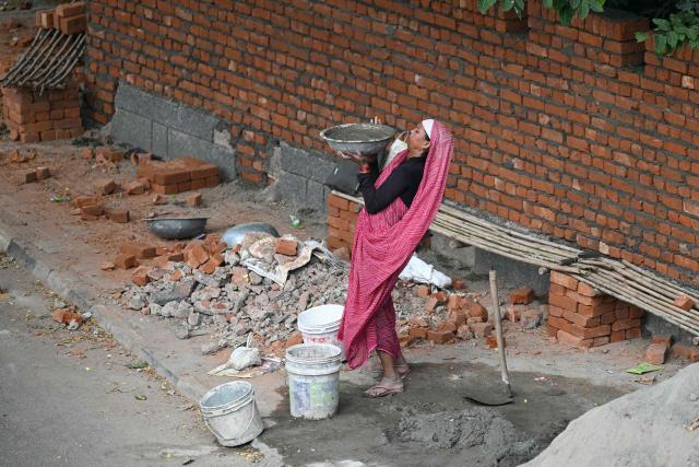 A woman works at a construction site in New Delhi on September 22, 2026. (Photo by Sajjad HUSSAIN / AFP)