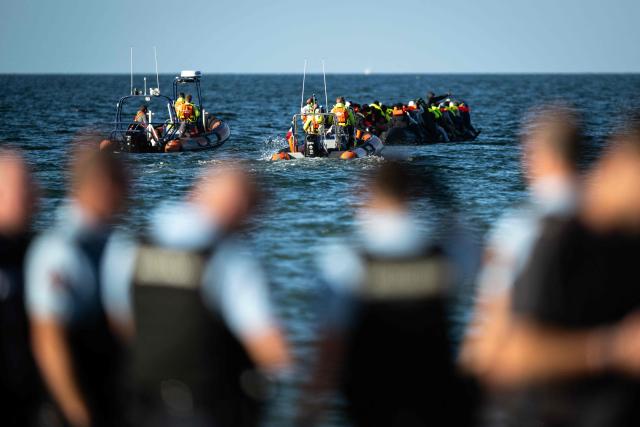 Migrants aboard a smugglers' boat attempt to cross the English Channel off the beach of Merville-Franceville-Plage, northwestern France, on September 21, 2026. As crossings of the English Channel become increasingly difficult from northern French beaches, migrants are trying new routes to reach England from southern regions such as the Calvados department, where the Channel is wider than along the northern French coast. (Photo by Guillaume SALIGOT / AFP)