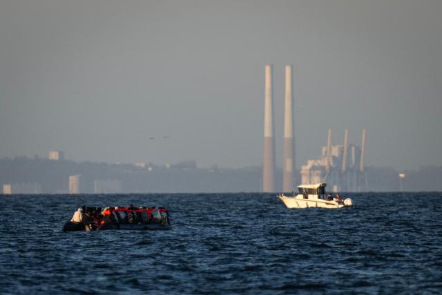 Migrants aboard a smugglers' boat attempt to cross the English Channel off the beach of Cabourg, northwestern France, on September 21, 2026, as the industrial port of Le Havre is visible on the background. As crossings of the English Channel become increasingly difficult from northern French beaches, migrants are trying new routes to reach England from southern regions such as the Calvados department, where the Channel is wider than along the northern French coast. (Photo by Guillaume SALIGOT / AFP)