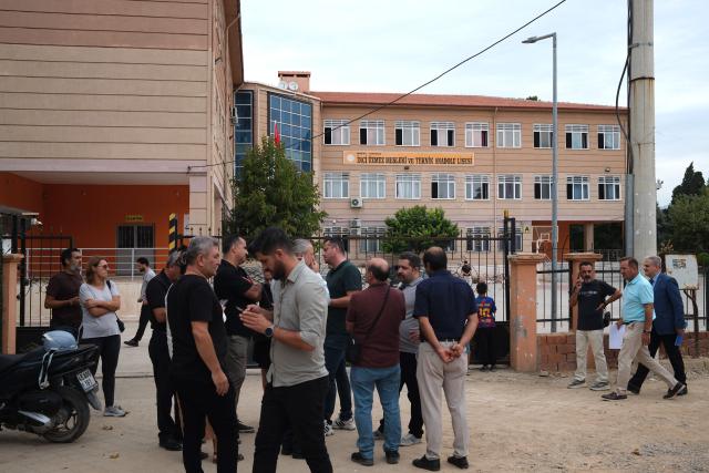 Members of teachers' unions gather in front of the high school where a gunman opened fire wounding eleven people and was detained shortly afterwards, in Turgutlu, an area west of the resort city of Izmir, on September 22, 2026. A teenager opened fire outside a high school in western Turkey on September 22, wounding 11 people before being detained by police, a minister said. The incident happened around 8:00 am (0500 GMT) in Turgutlu in Manisa province, near the western resort city of Izmir, the regional governor's office said. (Photo by ILKER ERAY / AFP)