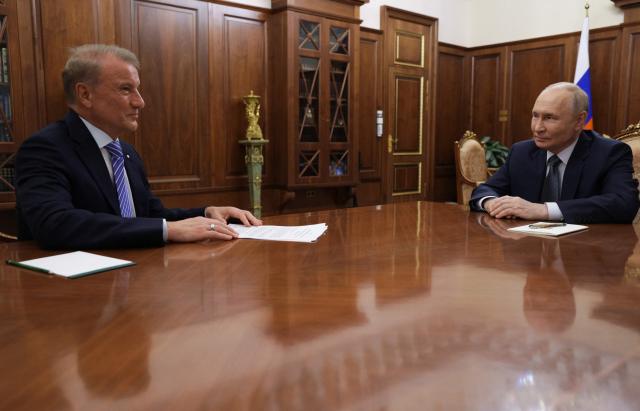 In this pool photograph distributed by the Russian state agency Sputnik, Russia's President Vladimir Putin meets with Sberbank's CEO German Gref in Moscow on September 22, 2026. (Photo by Vyacheslav PROKOFYEV / POOL / AFP)