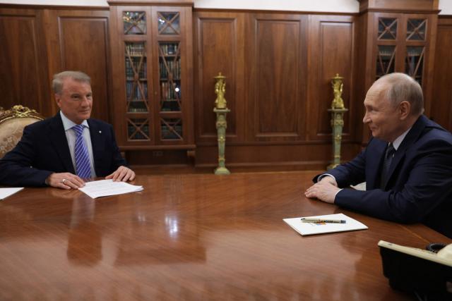 In this pool photograph distributed by the Russian state agency Sputnik, Russia's President Vladimir Putin meets with Sberbank's CEO German Gref in Moscow on September 22, 2026. (Photo by Vyacheslav PROKOFYEV / POOL / AFP)