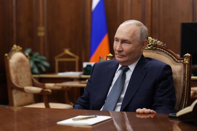 In this pool photograph distributed by the Russian state agency Sputnik, Russia's President Vladimir Putin attends a meeting with Sberbank's CEO in Moscow on September 22, 2026. (Photo by Vyacheslav PROKOFYEV / POOL / AFP)