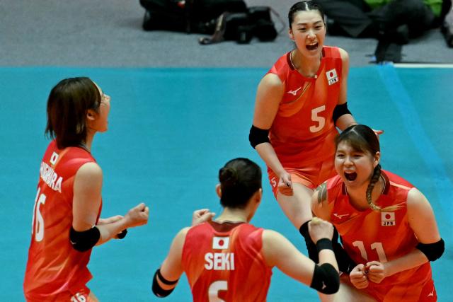 Japan's Hinata Shigihara (L), captain Nanami Seki (2L), Yoshino Sato (2R) and Nichika Yamada celebrate a point in the women's volleyball gold medal final match between Japan and China during the 2026 Asian Games at Park Arena Komaki in Komaki, Aichi prefecture on September 22, 2026. (Photo by MOHD RASFAN / AFP)