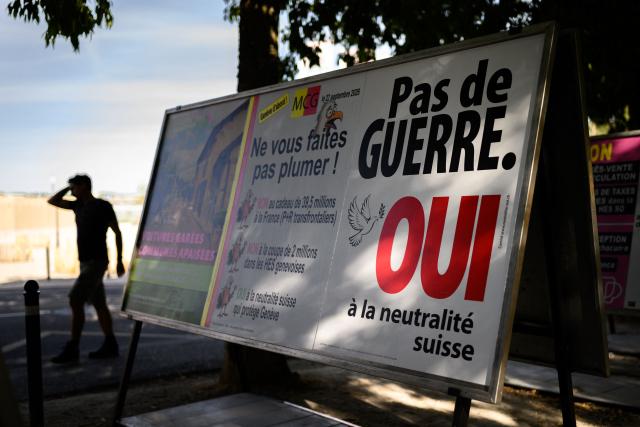 This photograph shows a campaign poster reading "No war, Yes to Swiss neutrality" on a street of Geneva, western Switzerland on September 21, 2026. On September 27, 2026, Swiss citizens will vote on a popular initiative seeking to enshrine Switzerland’s perpetual and armed neutrality in the Federal Constitution and limit participation in military alliances and sanctions against belligerent states. (Photo by Fabrice COFFRINI / AFP)