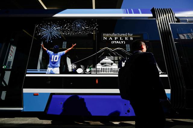 A sticker depicting Argentine football legend Diego Maradona from behind decorates a train built by Turkish manufacturer Bozankaya during the InnoTrans transport trade fair in Berlin on September 22, 2026. From September 22 to 25, 2026, around 600 companies from the Railway Infrastructure and Tunnel Construction sectors will present their latest products and services, ranging from digital planning and monitoring systems to innovative construction methods and sustainable solutions for Tunnel Construction and infrastructure management. (Photo by John MACDOUGALL / AFP)