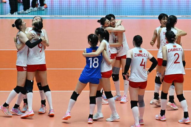 Team China celebrates their victory at the end of the women's volleyball gold medal final match between Japan and China during the 2026 Asian Games at Park Arena Komaki in Komaki, Aichi prefecture on September 22, 2026. (Photo by MOHD RASFAN / AFP)
